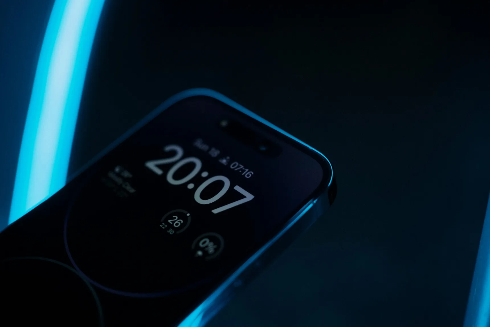 Smartphone mit leuchtendem Sperrbildschirm im Dunkeln, die Uhr zeigt 20:07